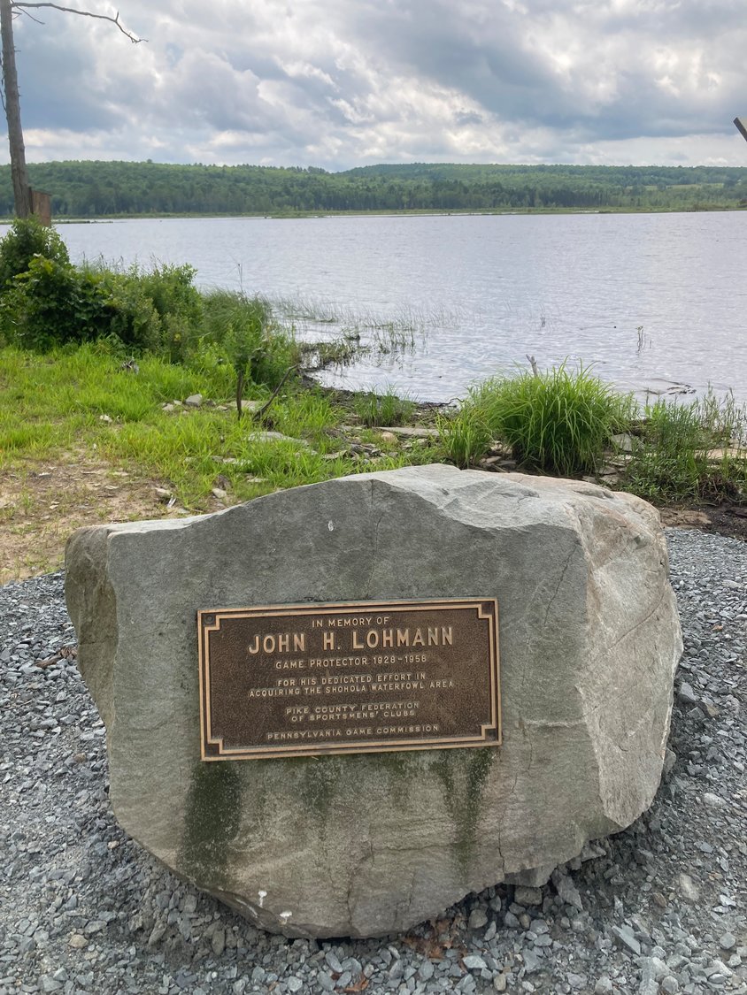 A memorial boulder, originally installed near the front parking lot along Route 6 at Shohola Waterfowl Area, has been relocated to the new observation deck at Shohola Lake. The boulder honors the memory of John H. Lohmann (1928-1958) for his “dedicated effort in acquiring the Shohola Waterfowl Area.” ..